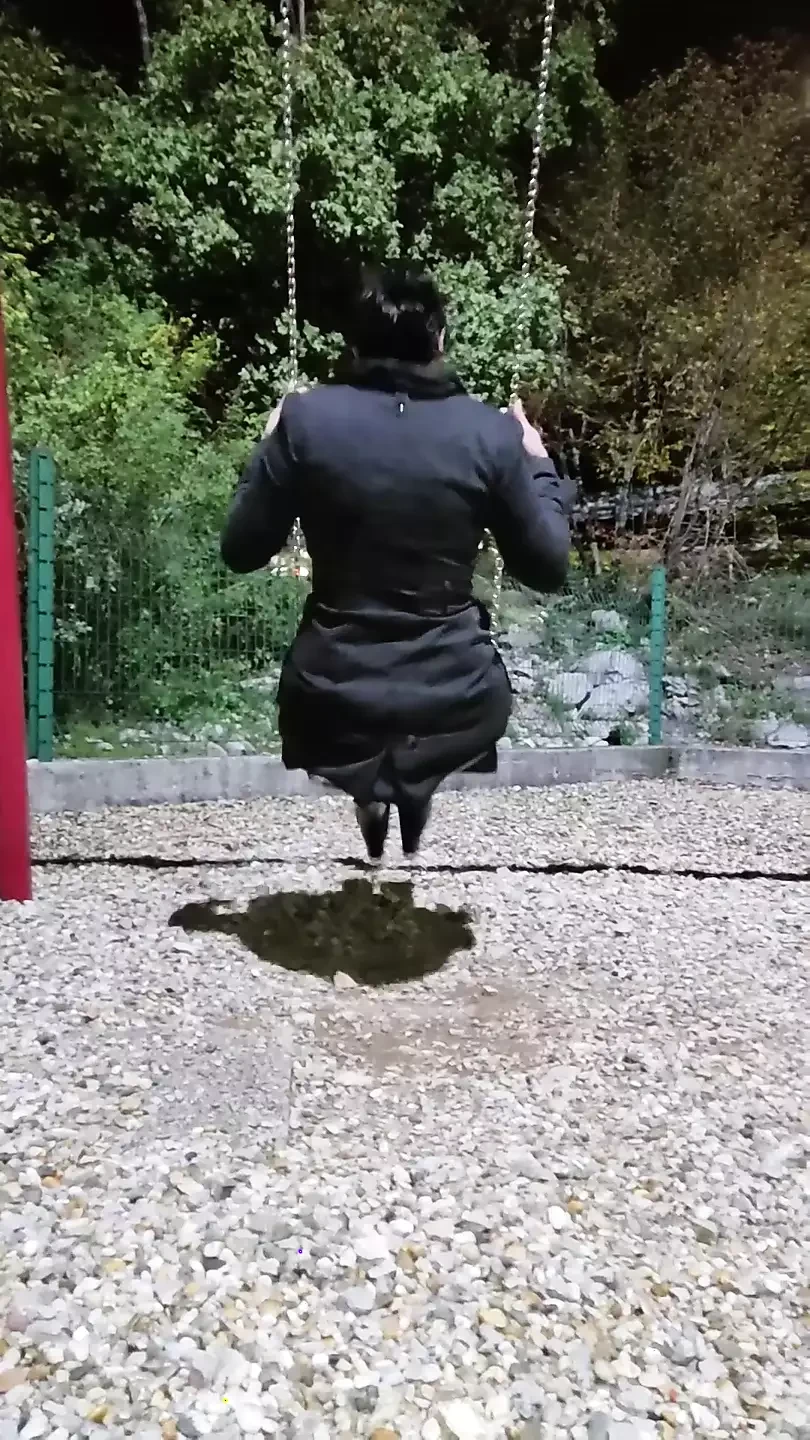 Step mom in stocking and coat swings on the swing and shows the buttplug in her ass