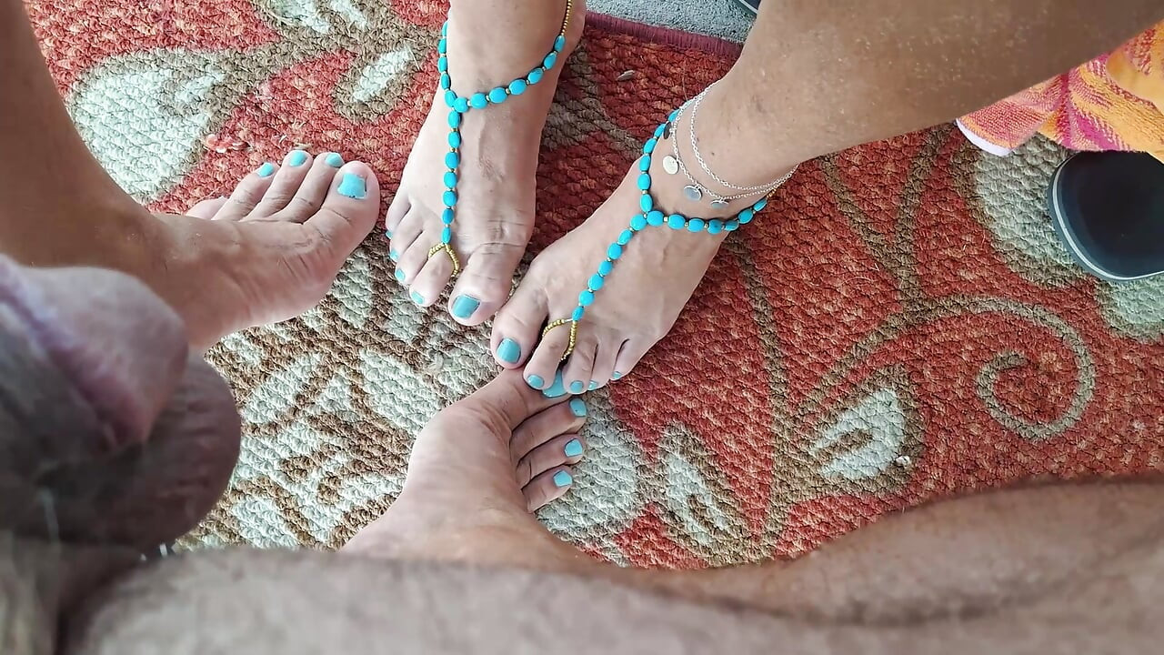 Rubbing my cum onto her feet with my toes