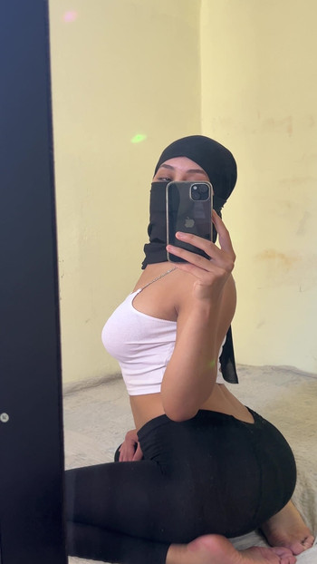 Arab Hijab Goddess Sits On Bed Teasing Fans While Arching Her Back And Showing Off Her Butt