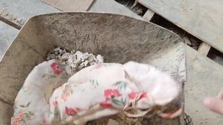 dumping floral dress in a construction trolley