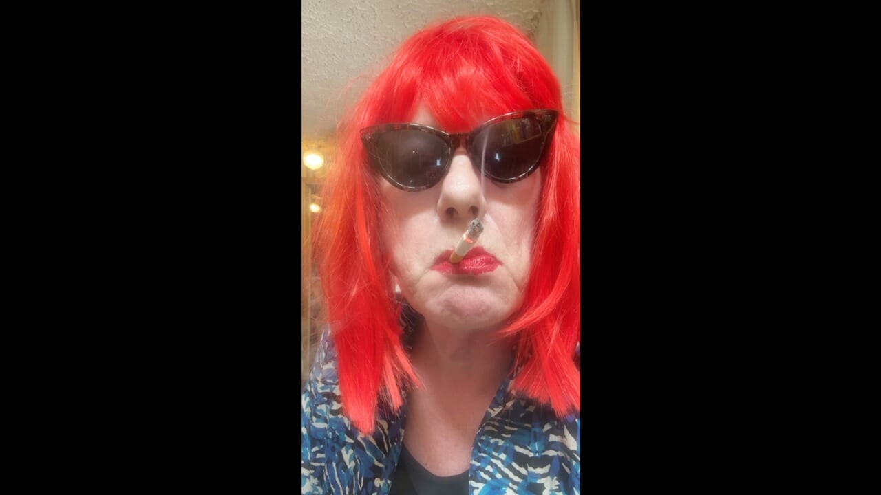 MRS. ROMAN DESTROYING A MARLBORO 100 MENTHOL CLOSE UP - WITH DANGLING AND NOSTRIL EXHALES