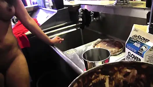 Two dykes in the kitchen playing with ice cream