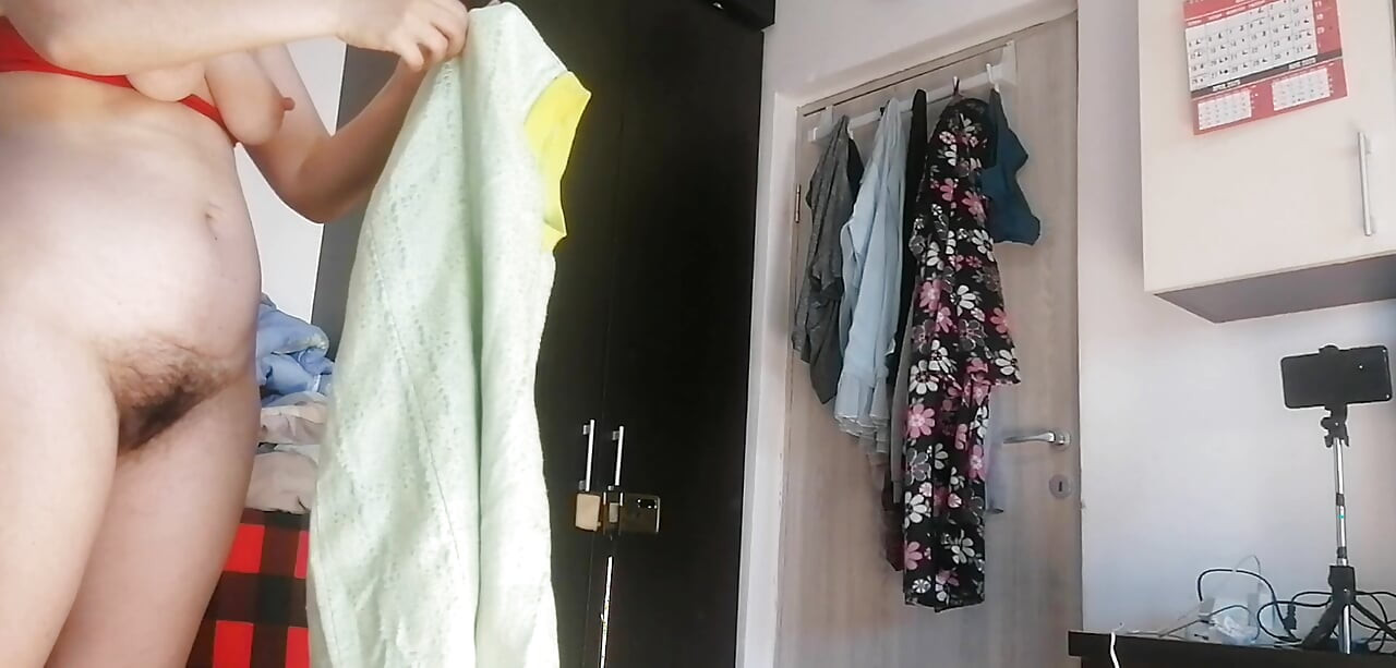 Amateur woman has fun trying on clothes and cutting them.