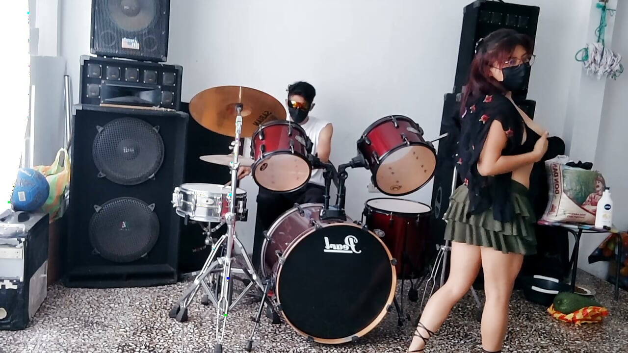 Best female friend performs a sexy dance for her male friend while he plays the drums.