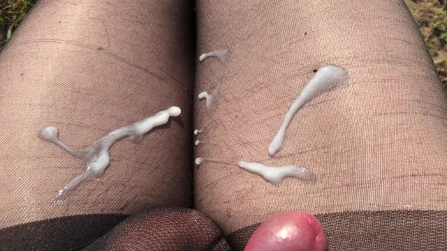 Crossdresser out in the fields posing in cheap black nylons