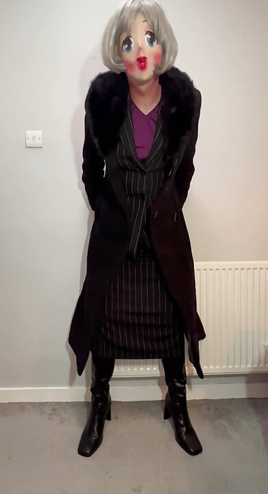 Crossdressing sissy dressed in her new skirt suit and long coat