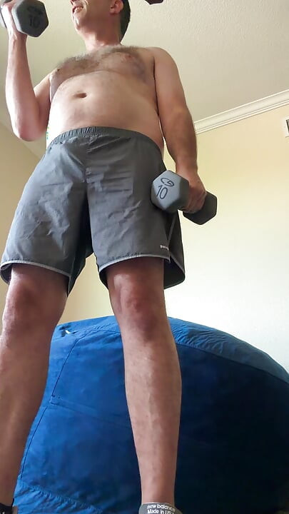Lifting weights with my shirt off. My big sexy hairy chest is out in full force