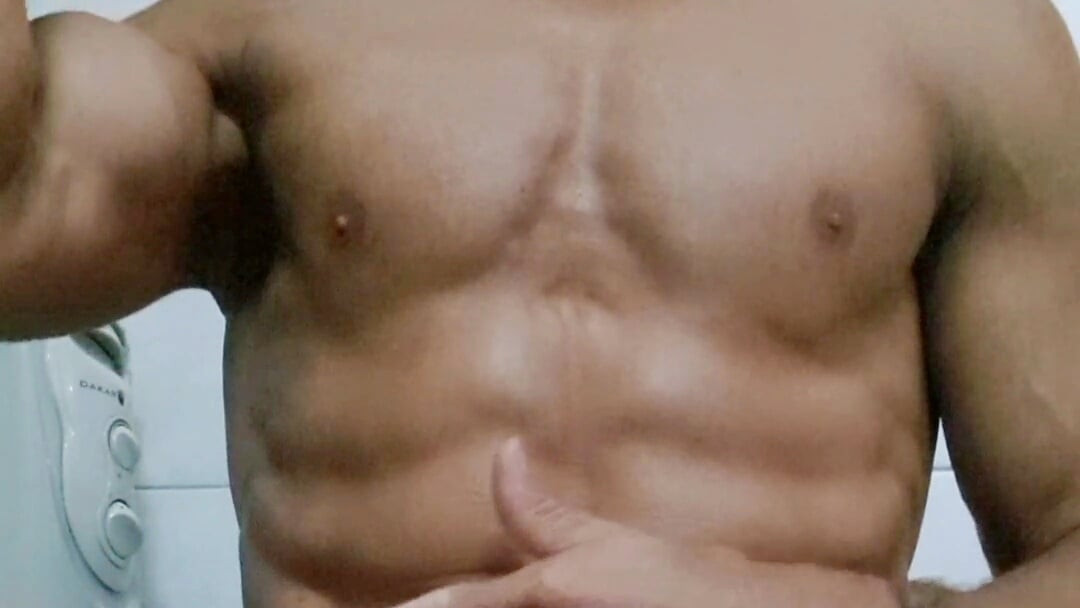 Sexy guy flexing his muscular arms, showing the sole of his foot and jerking off to a fan