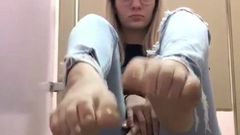 geeky blonde shows her feet in jeans
