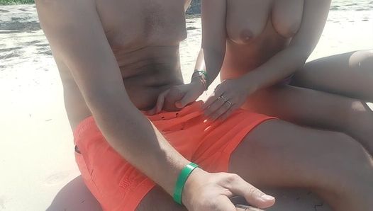 On the beach, a stranger gives a handjob in public