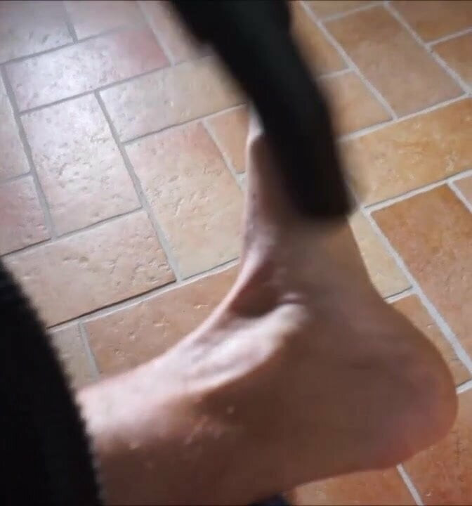 Boy vacuuming his feet