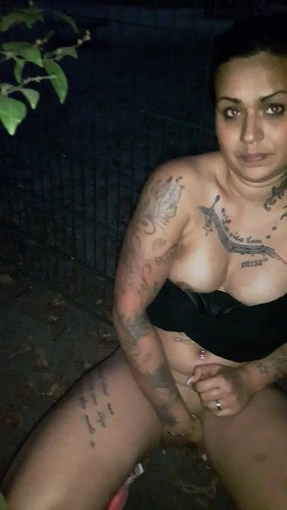 German Tattooed girl fingers herself outdoors