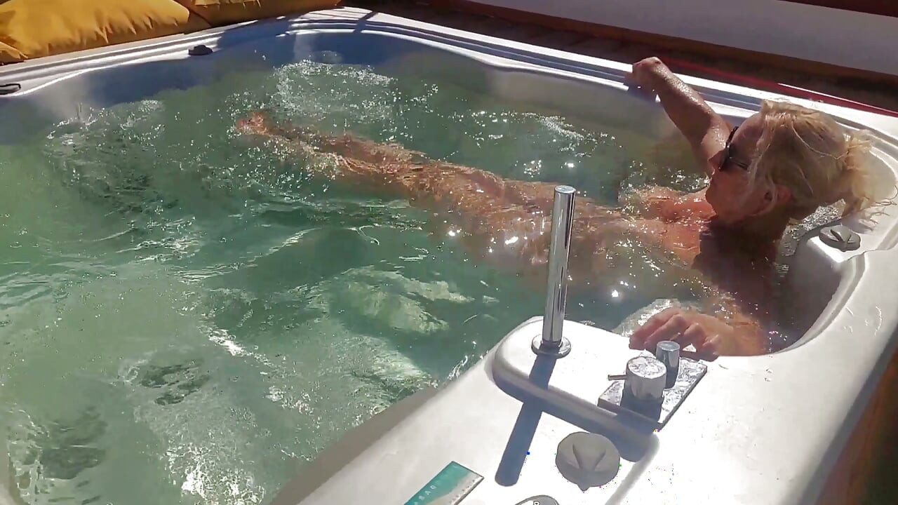 Une femme mature amateur sexy et nue aime les jeux en plein air dans la piscine