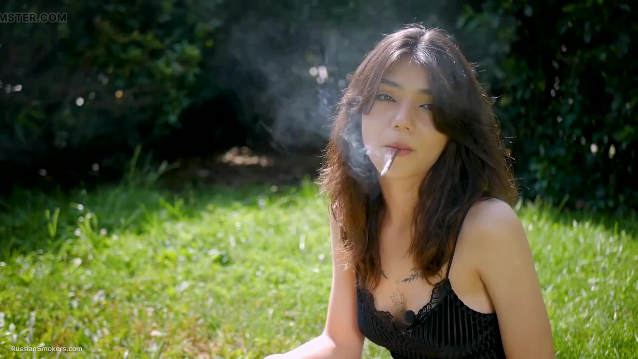 Arina Is Smoking One Black Cigarette Outdoors