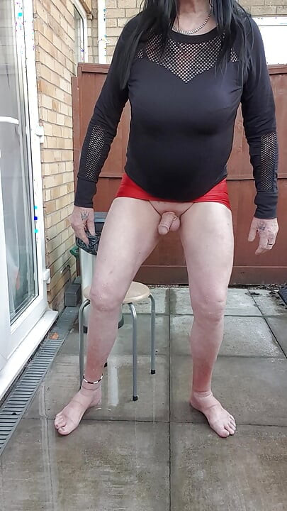 Dressed Gurl Spraying Her Bare Legs With Ice Cold Water