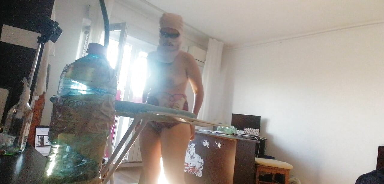 Amateur wife doing housework naked. Sexy and naughty wife trying on the clothes she cuts.