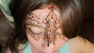 Masked brunette gives clothed titty fucking