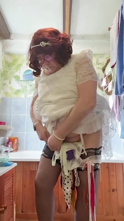 Dressed in a white lace dress to pee in a bottle