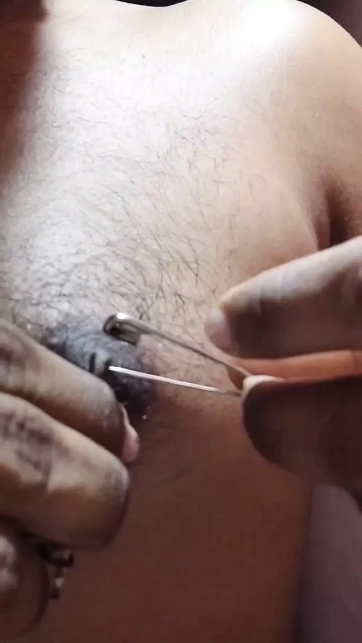 Man piercing  nipple and torture