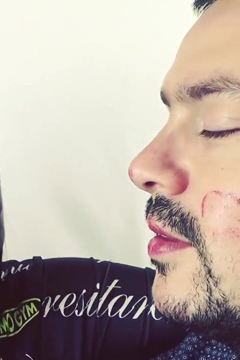 Covering Alex with red shiny lipstick kisses all over his face!