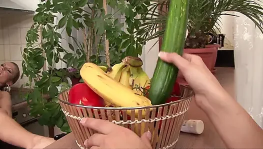 Three lesbians are playing with a cucumber