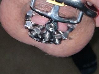 close up of the set screw in my chastity cage