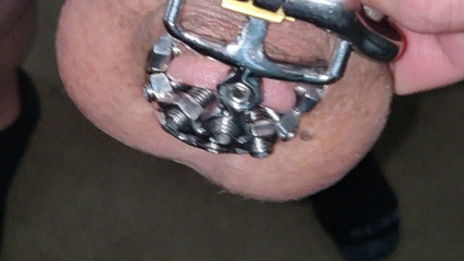 close up of the set screw in my chastity cage