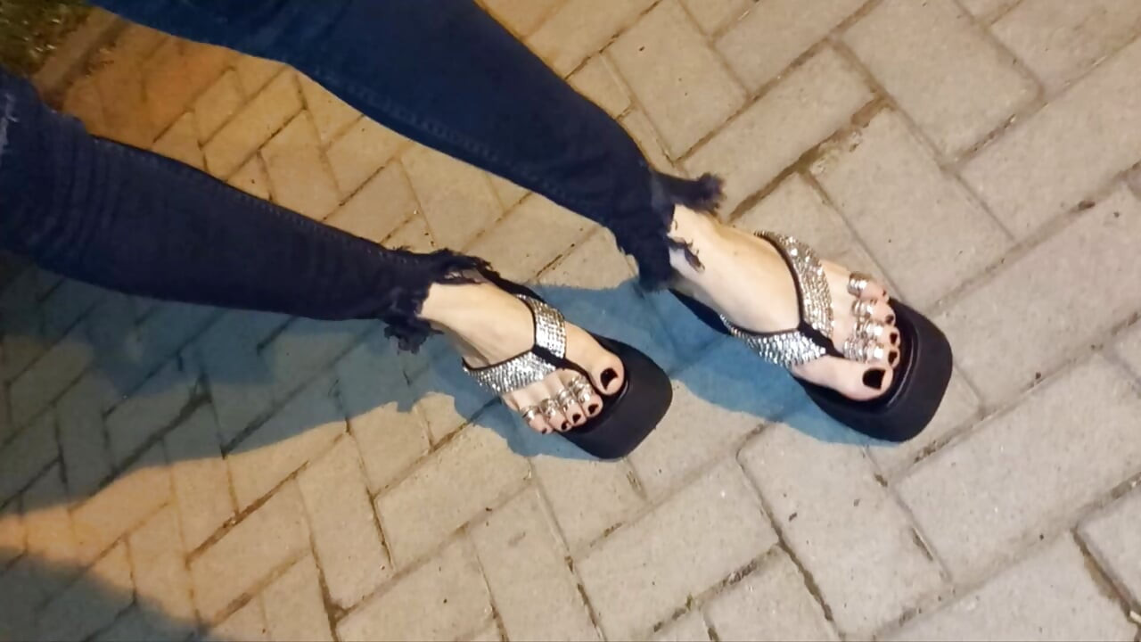 I wear platform flip-flops and tight jeans, showing off my feet.