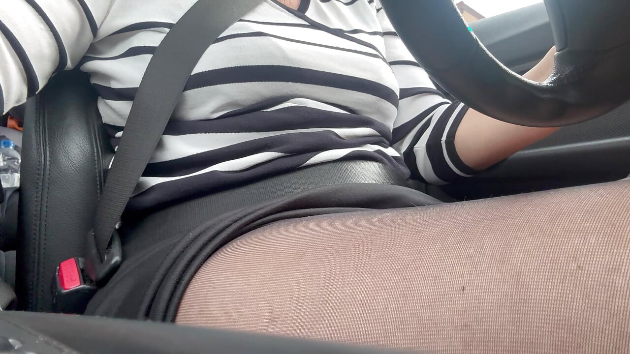 Elegant mature woman in nylon pantyhose driving home from the office