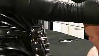 Latex Dominant Master with his Caged Boot Worshipper