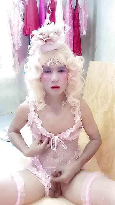 Oanh Le transgender wearing sexy porn clothes playing with a fake can