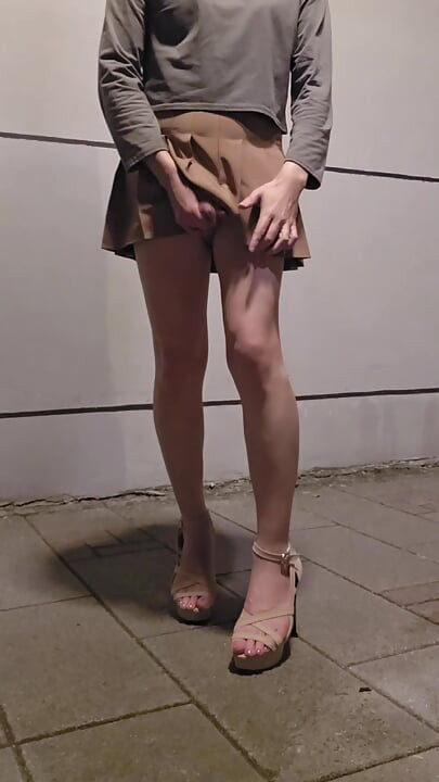 Shemale Ting Xuan masturbates outdoors in a miniskirt and high heels.