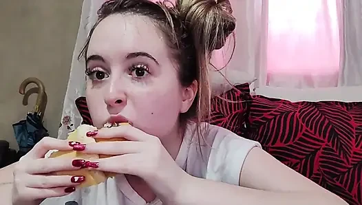 Eating an omelette sandwich with cherry tomatoes