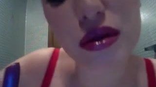 Sexy woman putting on lipstick