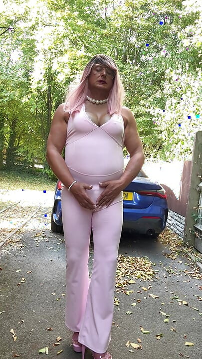 Crossdresser kellycd2022 u ružičastom kombinezonu i štiklama