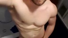 Male strips and smiles to the camera
