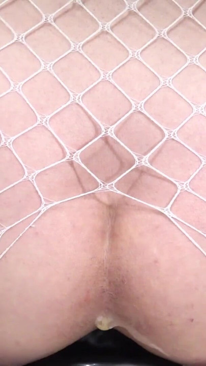 Iconic moment from "White Fishnet Sissy #14 - Riding a huge 95mm anal plug placed on a chair -"