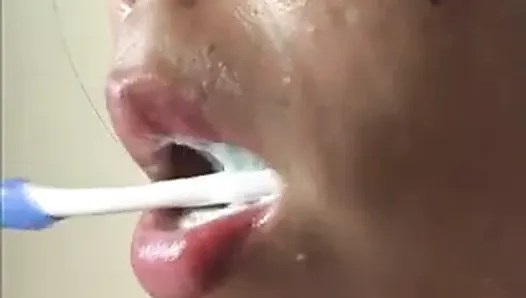 Close-up of Japanese girl brushing teeth sexily