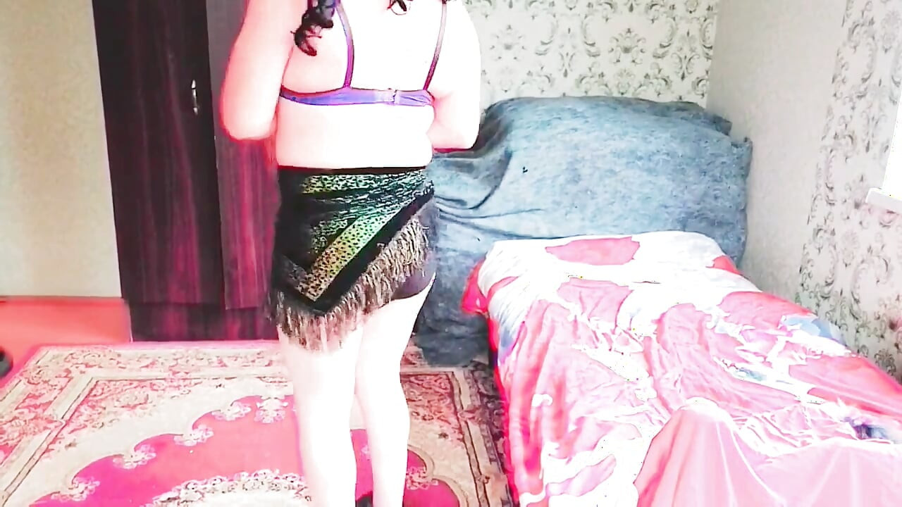 Cute femboy lifting skirt slightly under soft lights