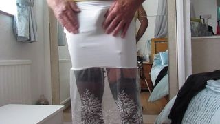 Tight white skirt showing suspender bumps