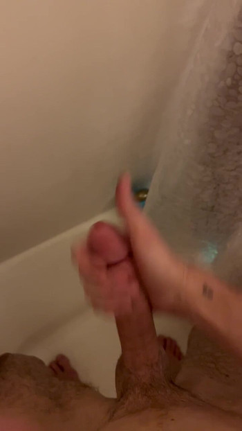 Young slim twink strokes big cock, squirts in the shower.