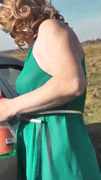 Key moment from "Milf beautiful sexy blonde outdoors on river bank washes car without panties and bra under dress. No"