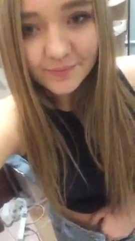 Showing off her nipple piercings