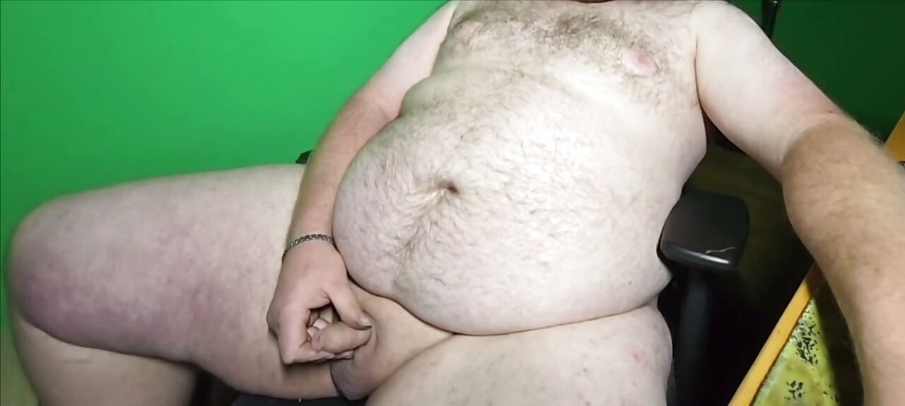 A fat boy with a small dick is masturbating.