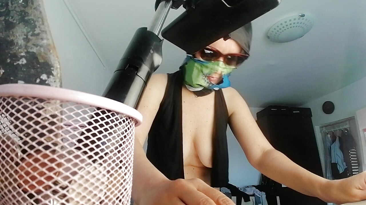 Sexy brunette doing naked chores around the house.
