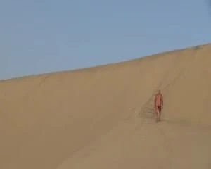 man naked on huge dunes