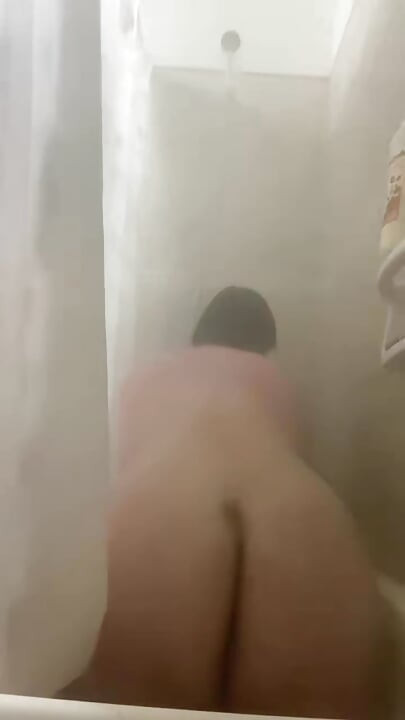 Alone in thong in the bathroom showing her ass and pussy pissing
