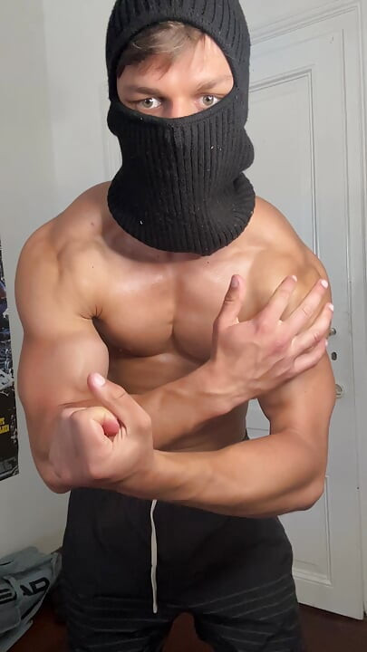Masked hunk showing off his muscles