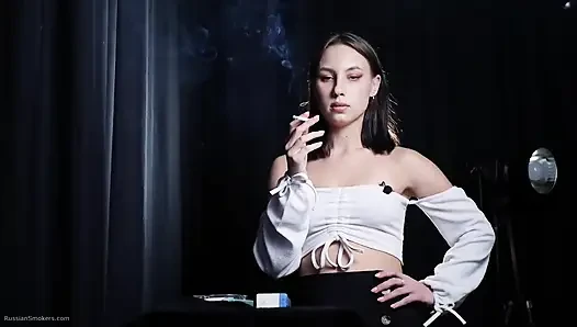 Elegant Brunette Smoking Cigarette in Dark Studio Scene