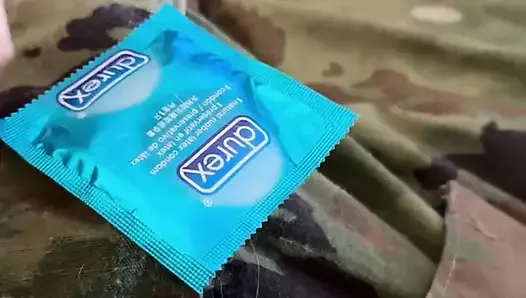 Jerking off in uniform into a condom already full of the cum of buddies